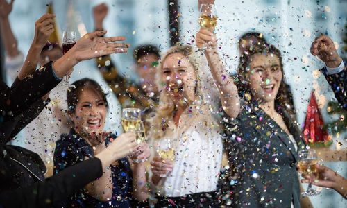 Group of people celebrating with confetti and champagne