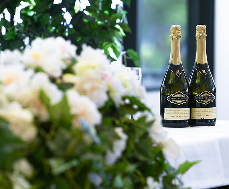 photo of flowers and two bottle of champagne