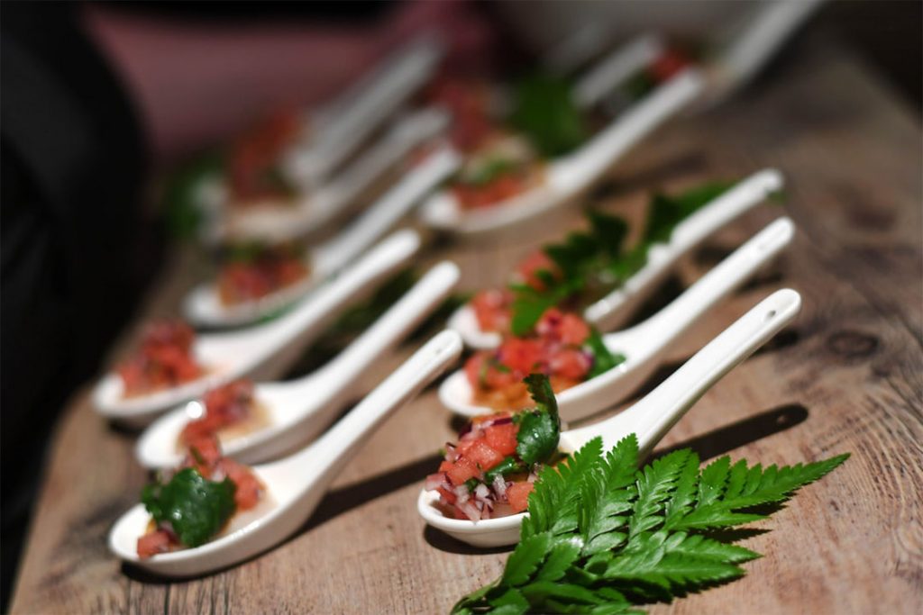 photo of a row of canapes with bruschetta